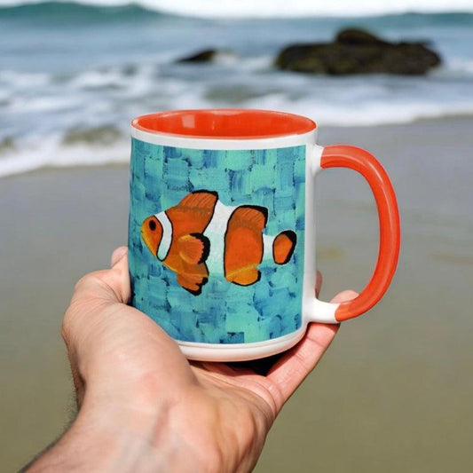 Clownfish Mug - Dorrin Gingerich Art - lownfish artwork mug held on beach – colorful canvases turned into affordable artwork drinkware, sea art work style.