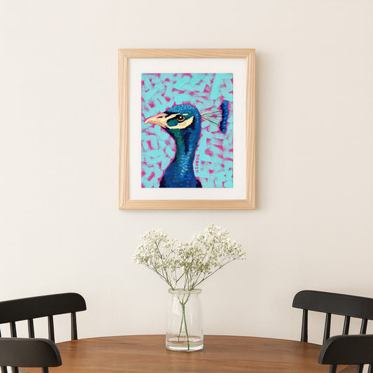 Framed artwork of a peacock on a wall above a table with a vase of flowers.
