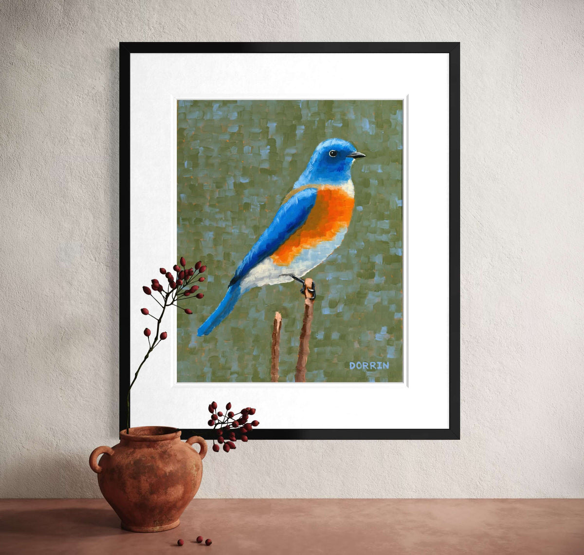 Eastern bluebird framed art print leaning against wall with terracotta pot and dried berries