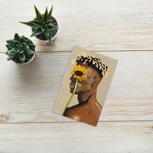 Card with a stylized illustration of a person holding a sunflower on a wooden surface with potted plants.