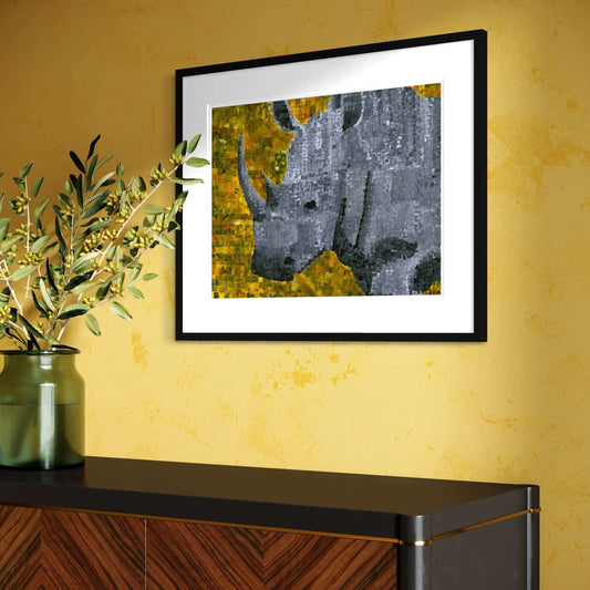Framed rhino art print on a golden wall above a dark wood cabinet