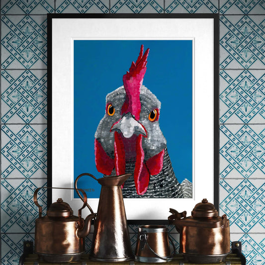 Framed rooster fine art print by Dorrin Gingerich displayed above copper kettles on patterned tile wall