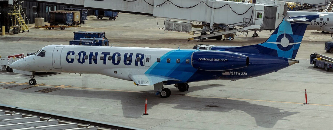 An airplane with blue and white colors parked on the tarmac.