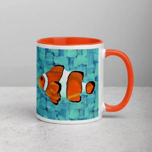 An orange and black clown fish swimming on a blue background, on a coffee mug.