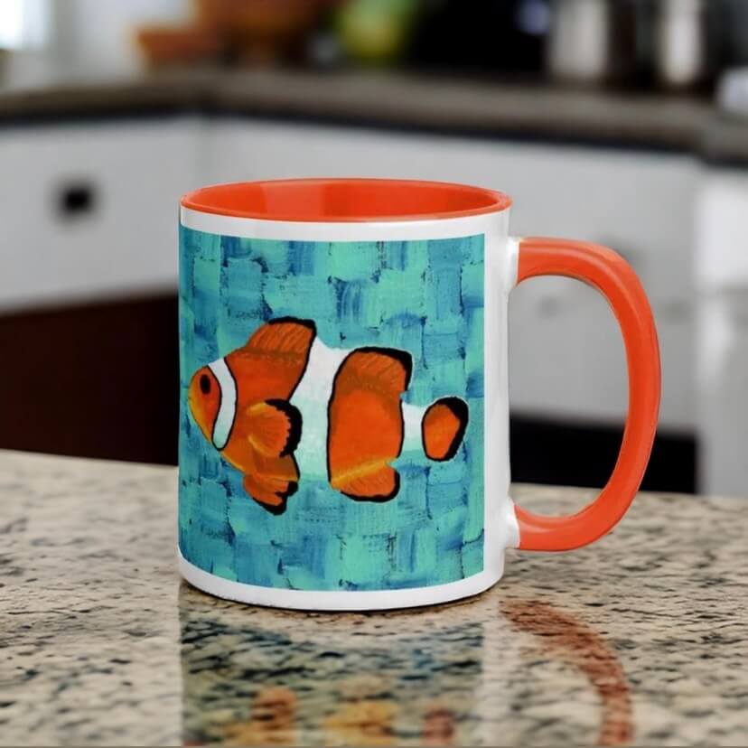 An orange and black clownfish swimming on a coffee mug, adding a touch of color and whimsy to your morning routine.