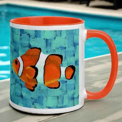 Clownfish on a blue and orange mug, next to a pool.