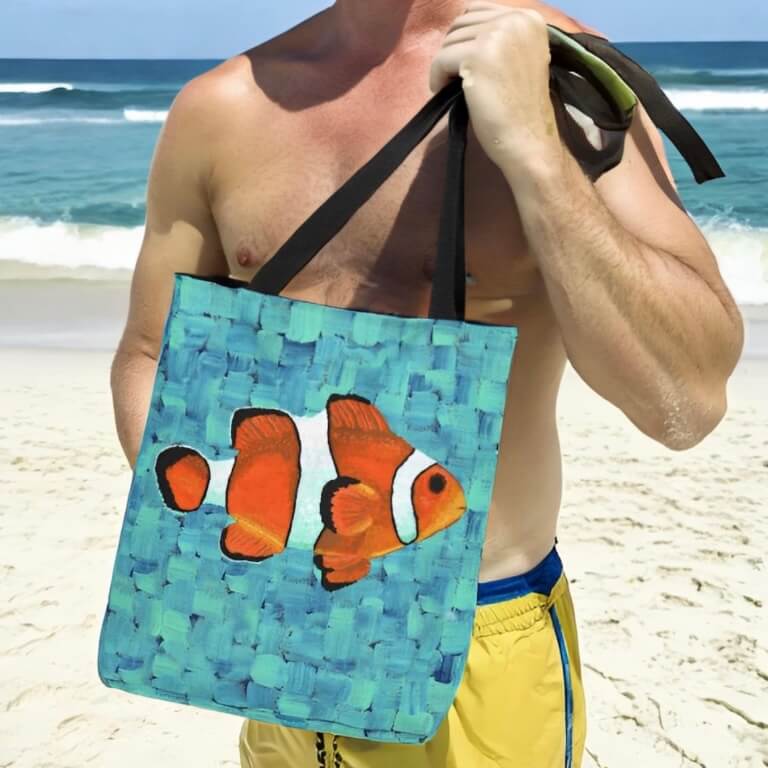 A man holding a tote bag with a clown fish image. A stylish accessory with a touch of underwater charm!