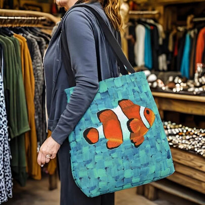 A woman holding a tote bag with a clown fish image. A stylish accessory with a touch of underwater charm!