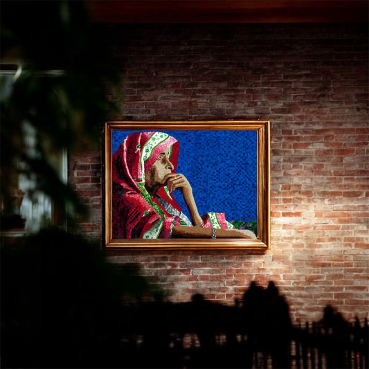 Framed artwork of a person in traditional attire on a brick wall.