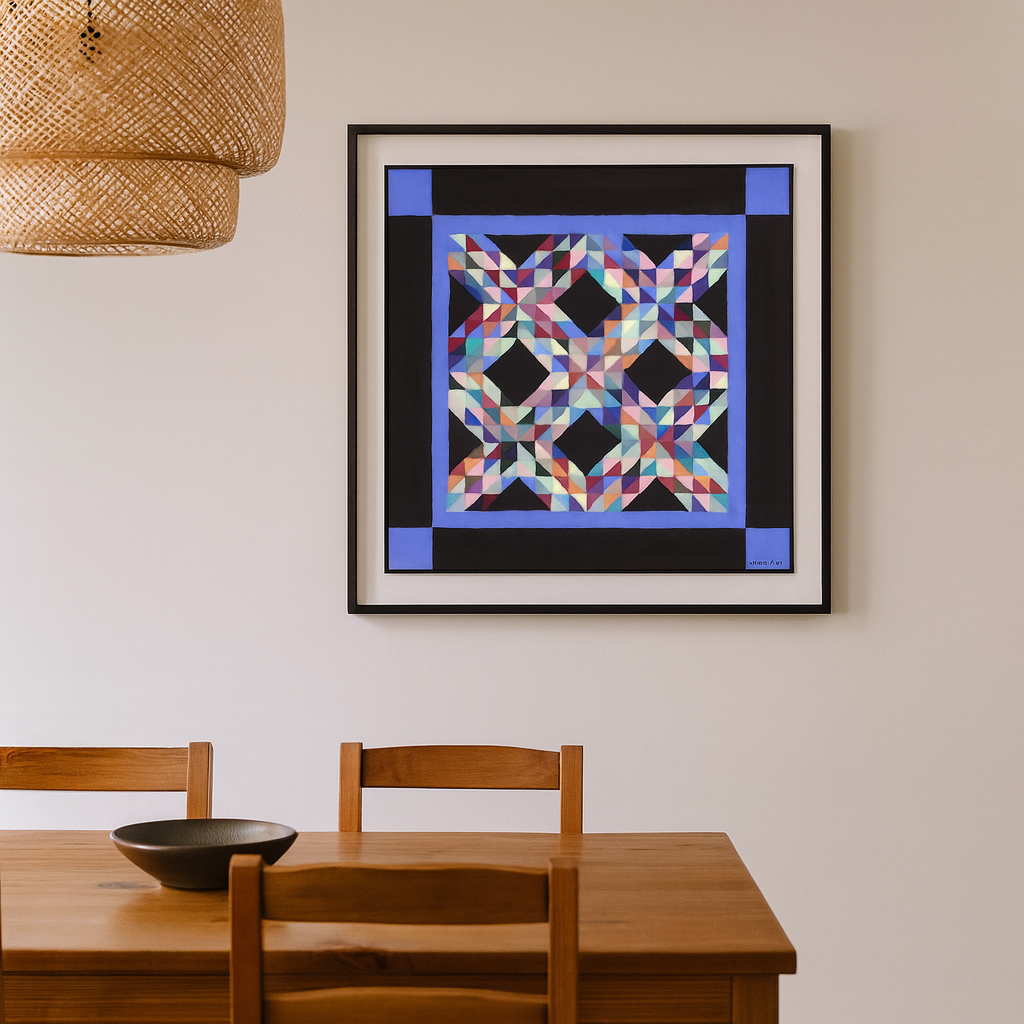 Framed colorful geometric art piece on a wall above a wooden dining table.