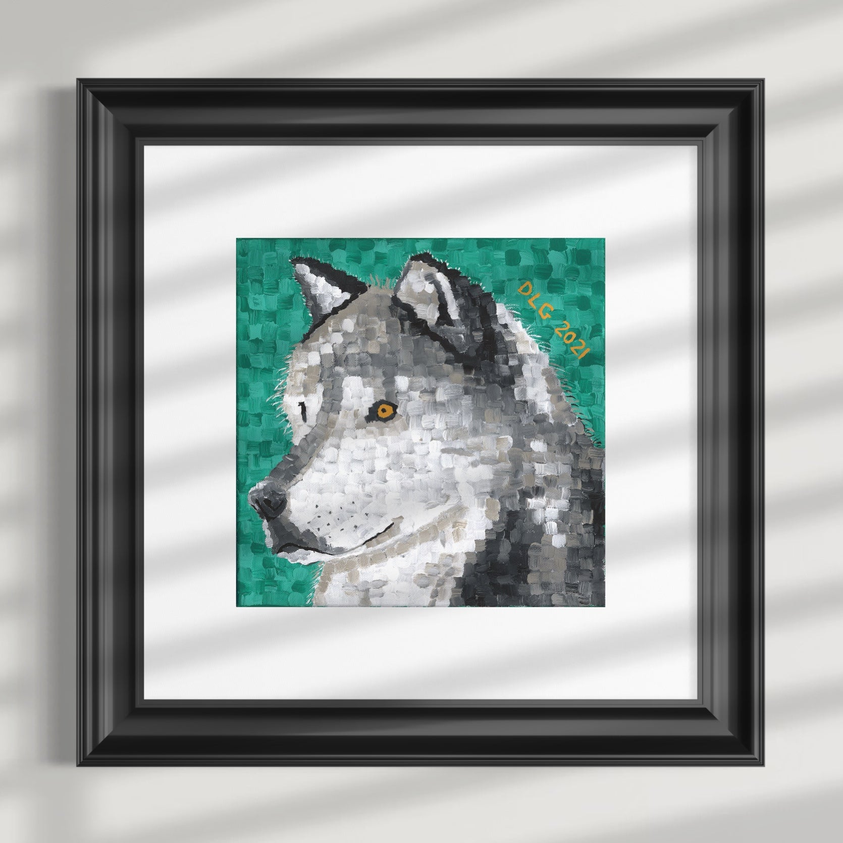 Framed artwork of a wolf's head on a textured wall