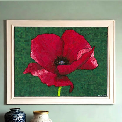 A vibrant red poppy showcased in a frame against a green wall. A stunning display of nature's beauty.
