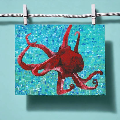 An octopus painting by Dorrin Gingerich, hanging on a clothesline, adding a touch of creativity to the scene.