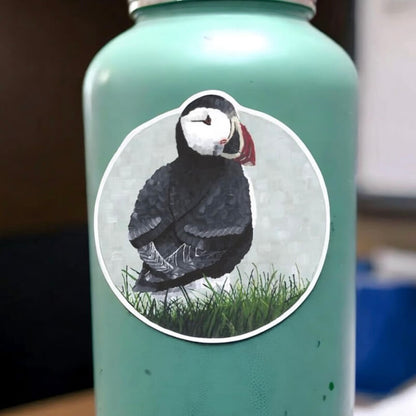 A water bottle with a cute puffin sticker on it, adding a touch of charm to your hydration companion.