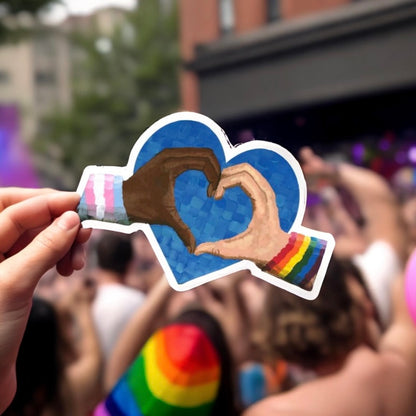 Person holding up heart-shaped sticker.