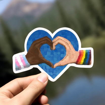 A hand forming a heart shape with two hands. Spread love and pride with these heart-shaped stickers!