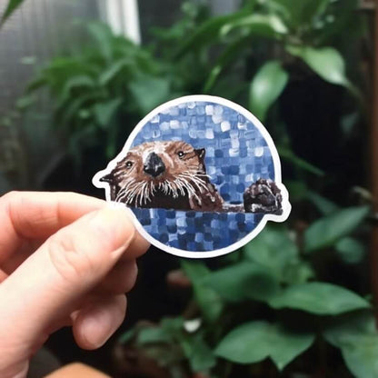 Adorable sea otter design in round sticker.