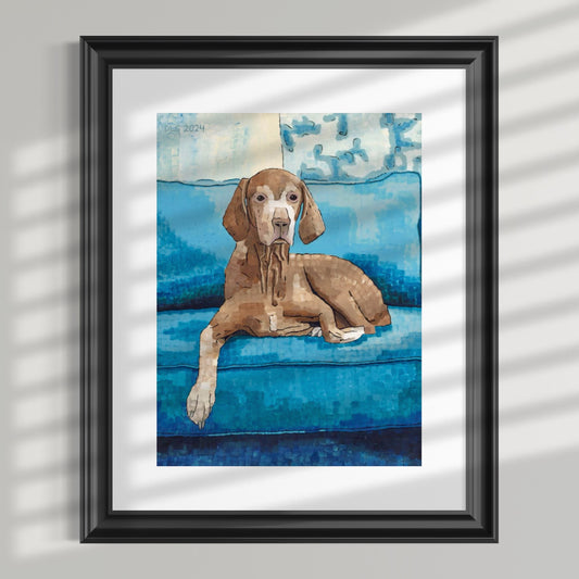 Framed artwork of a brown dog on a blue couch