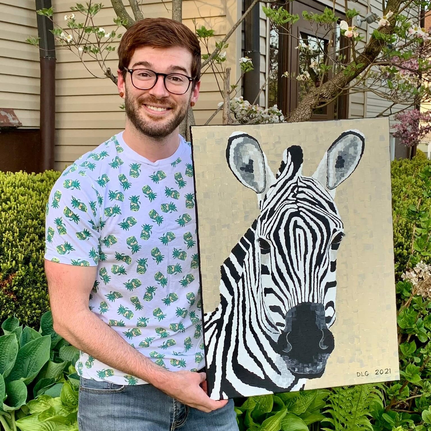 Artist Dorrin Gingerich holding the Zebra art print, a striking piece of modern animal wall decor designed to bring energy and personality to your space.