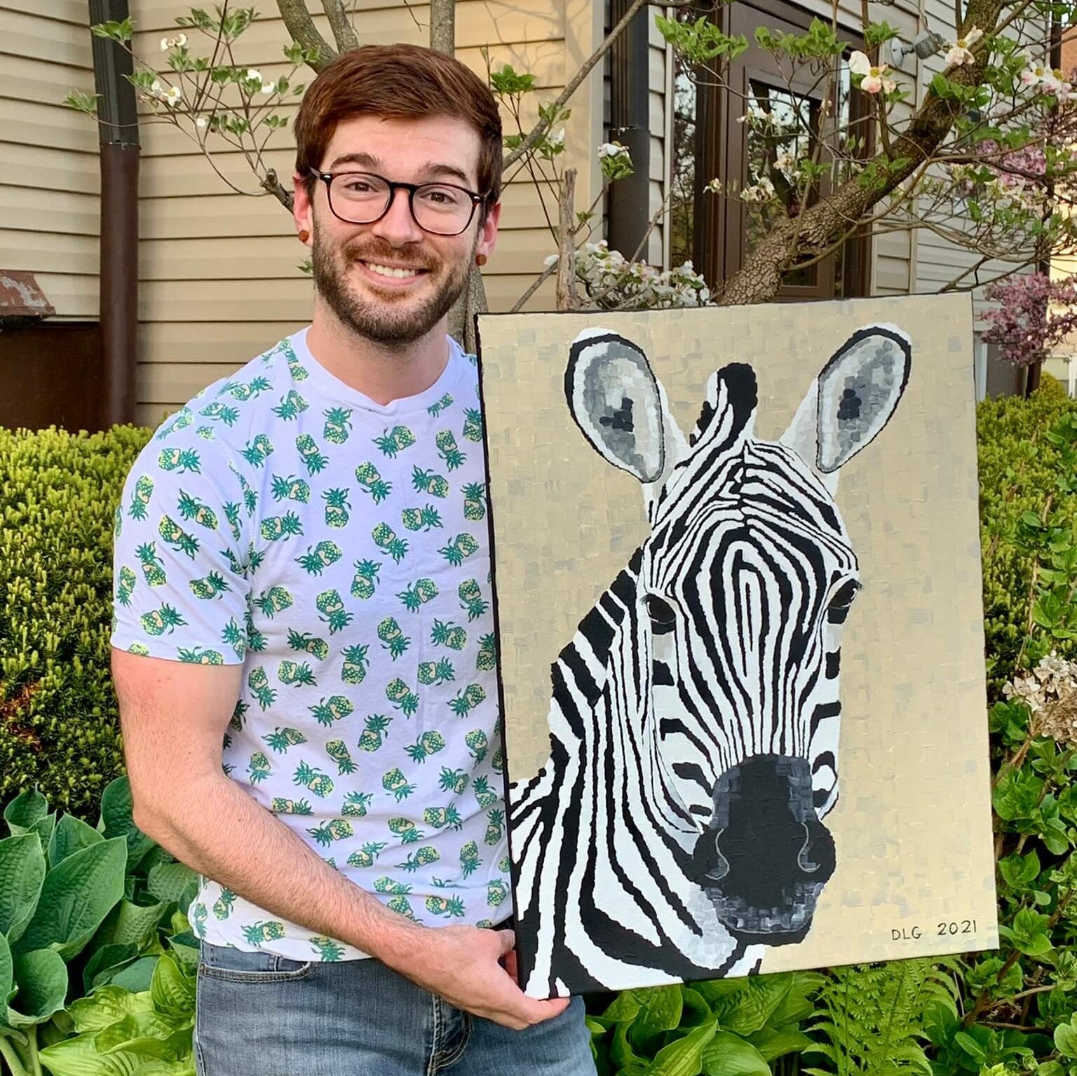 Artist Dorrin Gingerich holding the Zebra art print, a striking piece of modern animal wall decor designed to bring energy and personality to your space.
