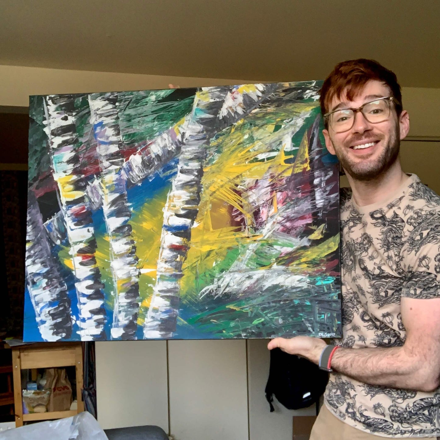 Dorrin Gingerich holding the original Active Forest 1 abstract birch tree painting