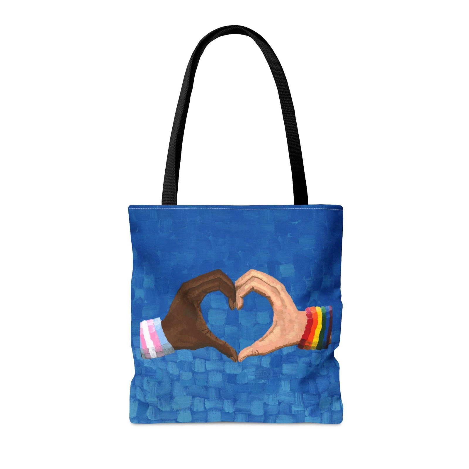 Loving Pride tote on a table next to a coffee mug — arts for LGBTQ community blended with practical, pride art work for everyday use.