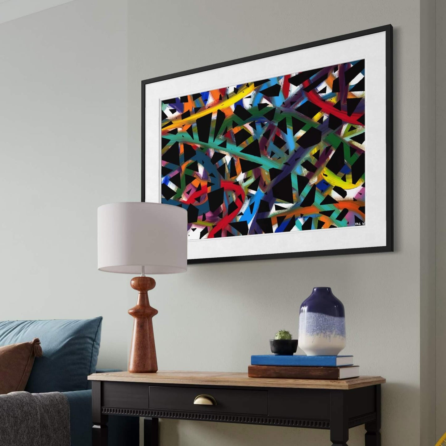 Framed Cross Roads print hanging above a wood console table with books and a vase