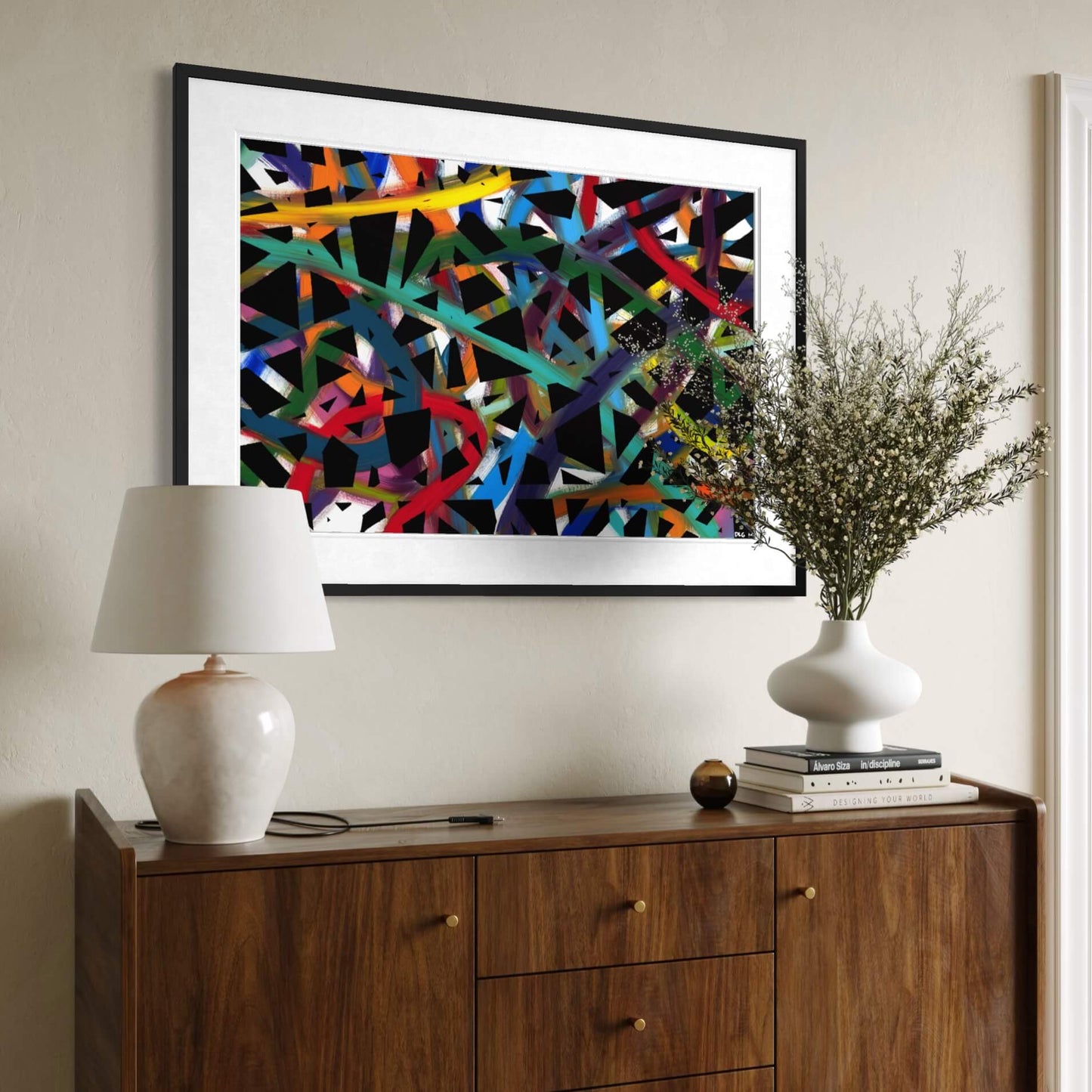 Framed Cross Roads print above a wood dresser styled with a lamp and plant
