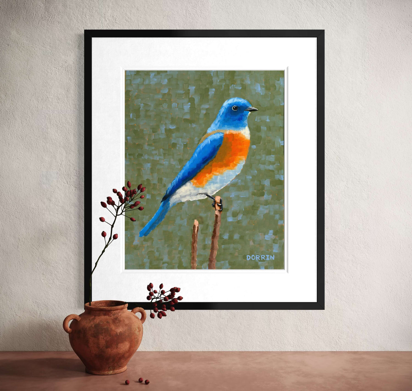 Eastern bluebird framed art print leaning against wall with terracotta pot and dried berries