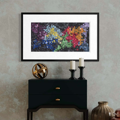 Framed First abstract print on a console with a bronze sphere and pillar candles