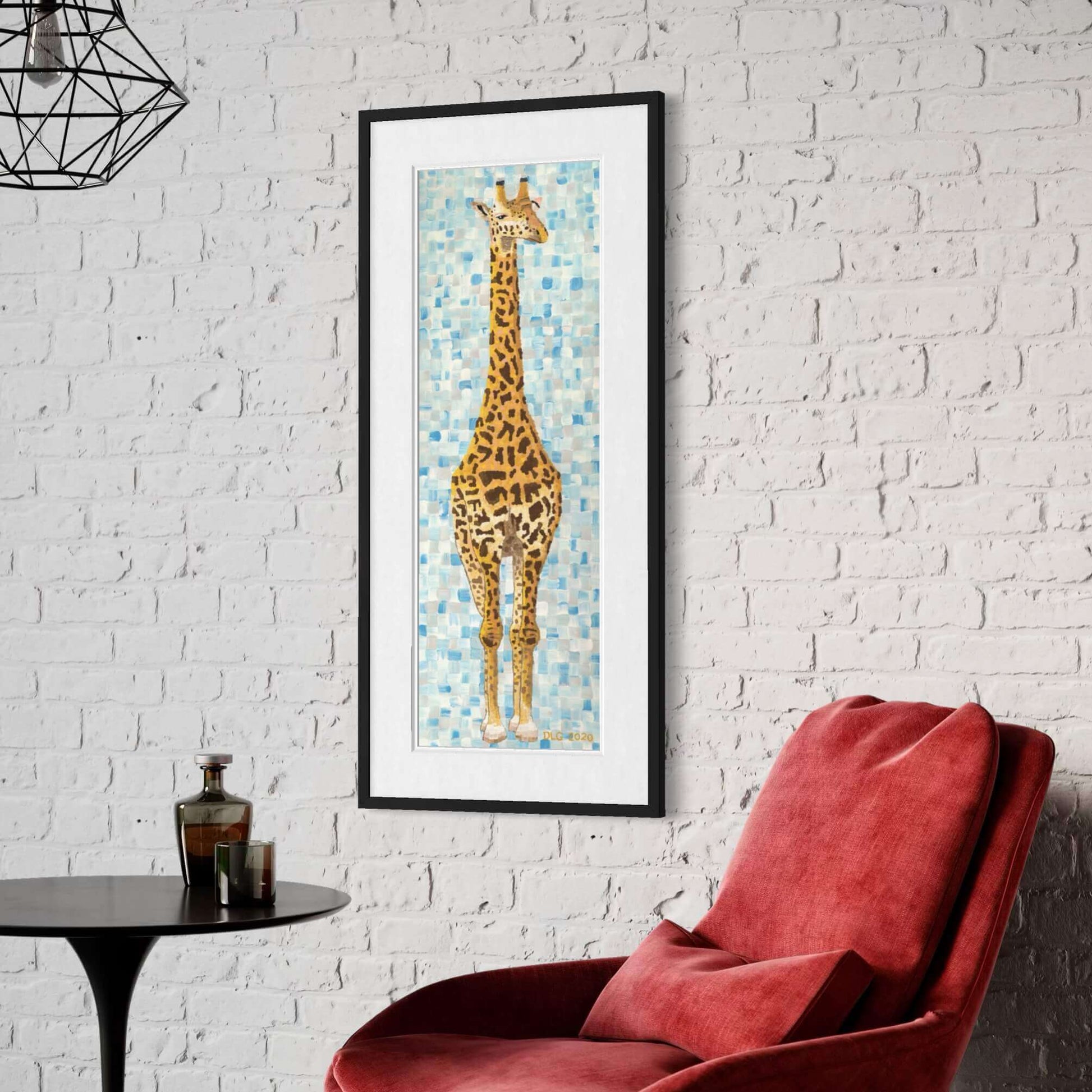 Tall framed giraffe art print on white brick wall above red armchair, safari wall decor