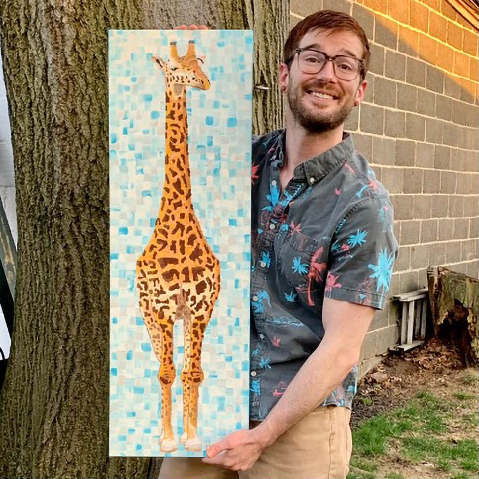 Dorrin Gingerich holding the original Giraffe painting outdoors, 12x36 wildlife art