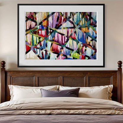 Framed Intersections print above a dark wood headboard with purple pillows