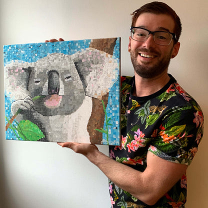 Koala art print, selfie of Dorrin Gingerich holding the original koala painting
