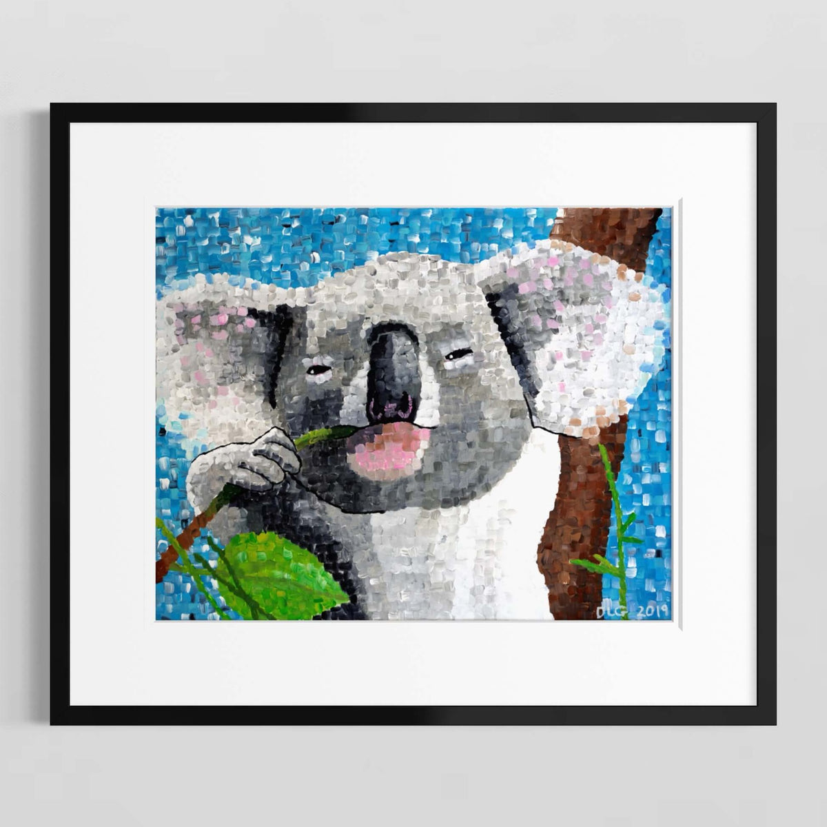 Koala art print in a black frame with white matting on a white wall