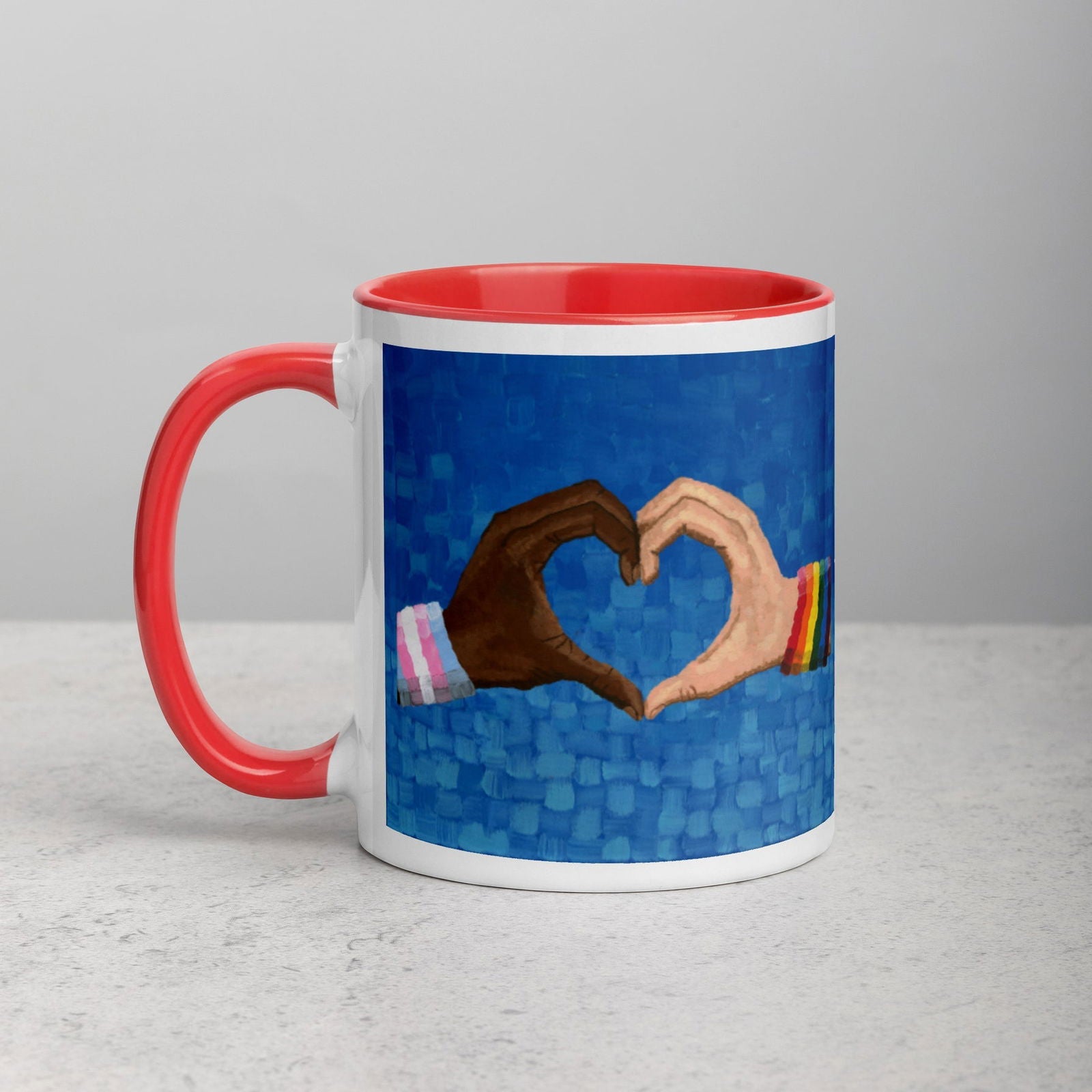 Loving Pride mug on a table with cozy decor and canvas wall hangings — a celebration of love, pride, and LGBTQ community in everyday life.