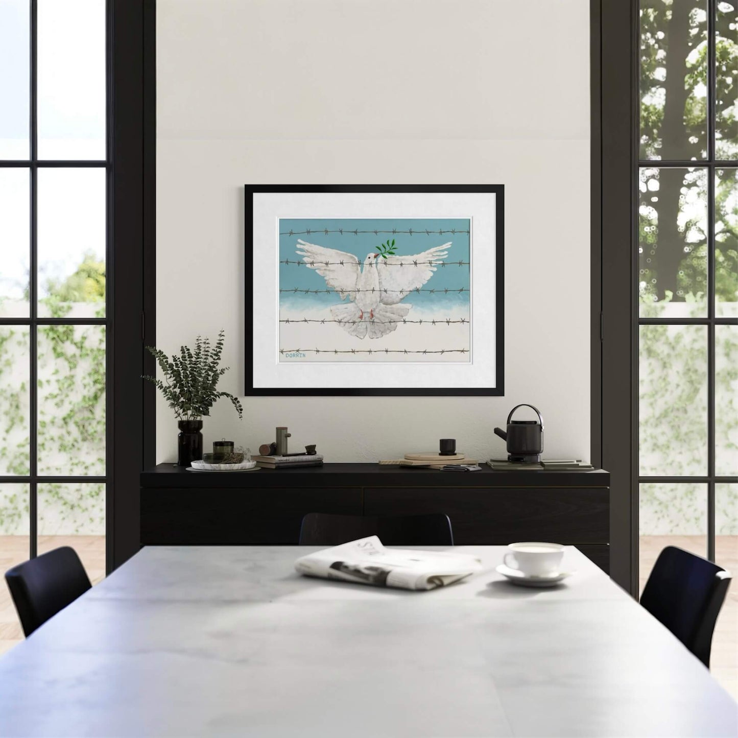 Framed peace dove art print displayed in modern dining room above dark credenza with floor-to-ceiling windows