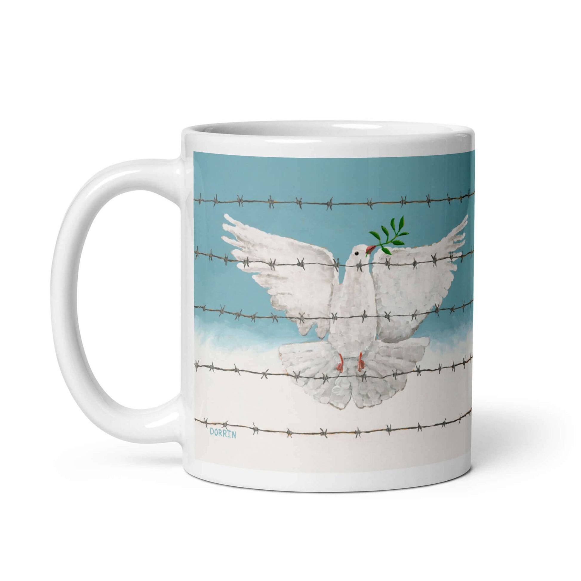 Mug with a design of a dove holding an olive branch behind barbed wire on a blue sky background.