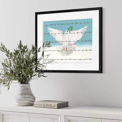 Framed peace dove political wall art print hung above white sideboard with olive branch arrangement and vintage book