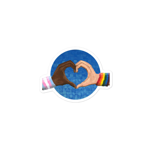 A hand holding the Loving Pride sticker before application — a perfect print artist expression of love artwork and LGBTQ pride on the go.