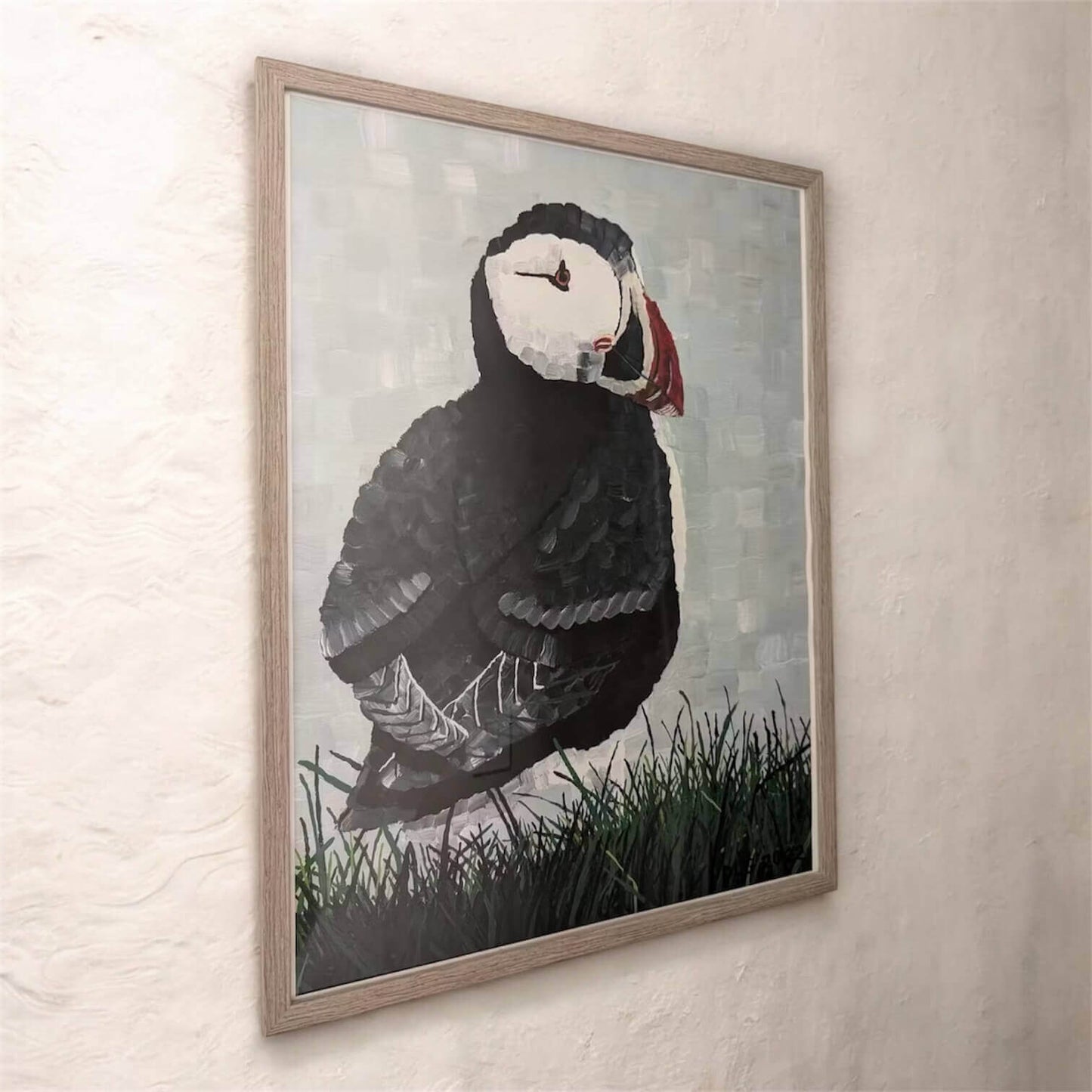 Puffin print in natural wood frame on textured wall, Scandinavian-style coastal bird art