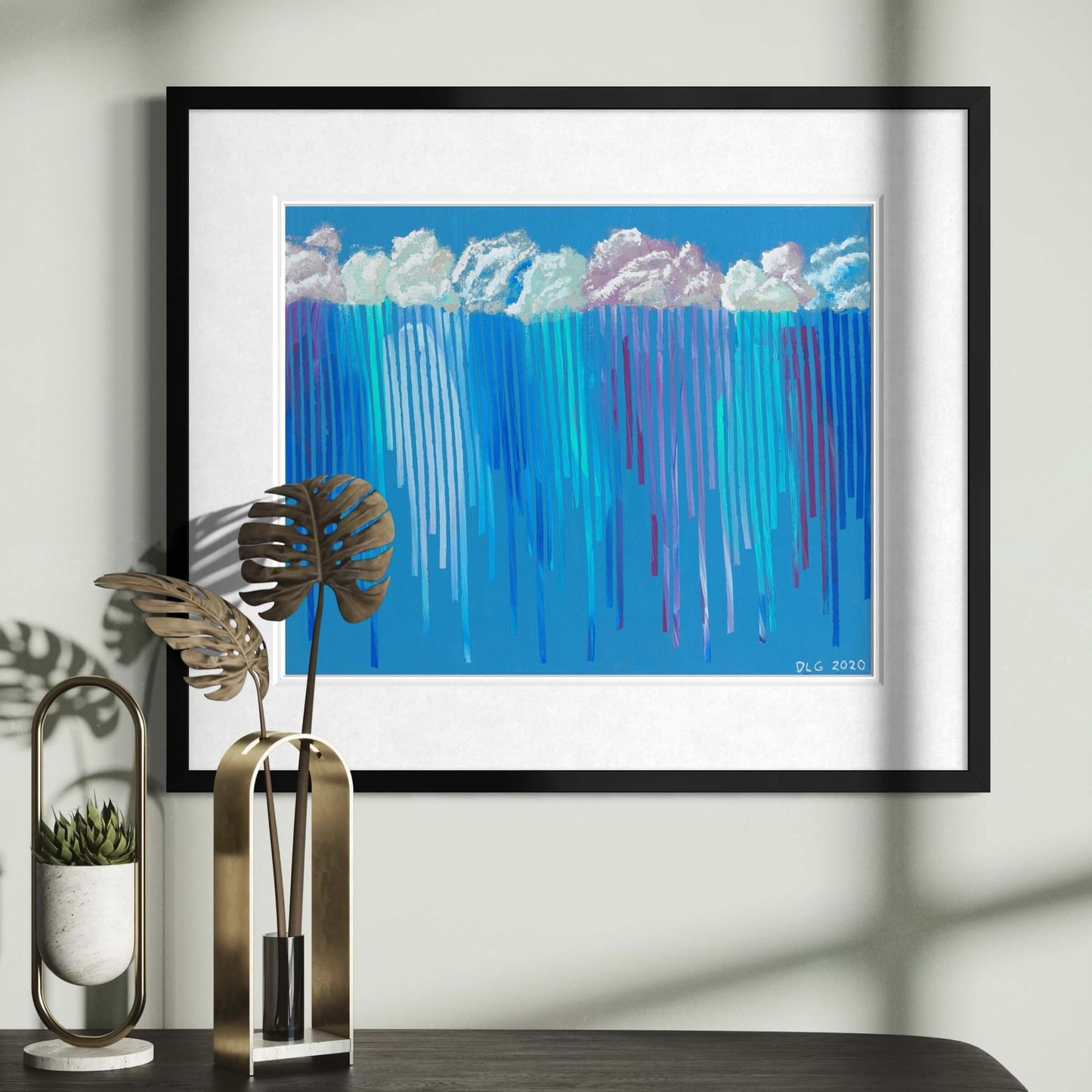 Framed Rain on Me art print displayed above a console table with dried palm leaves