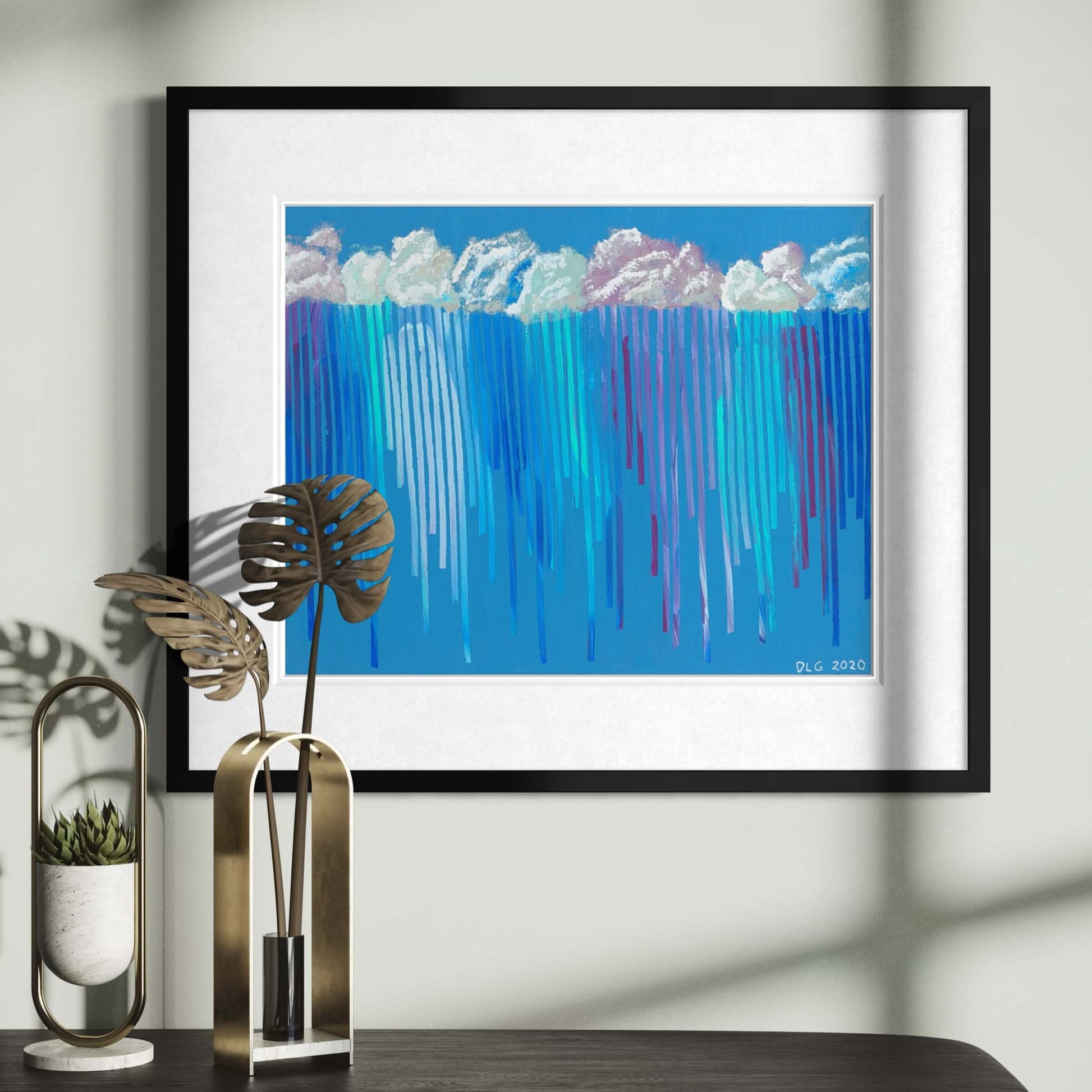 Framed Rain on Me art print displayed above a console table with dried palm leaves