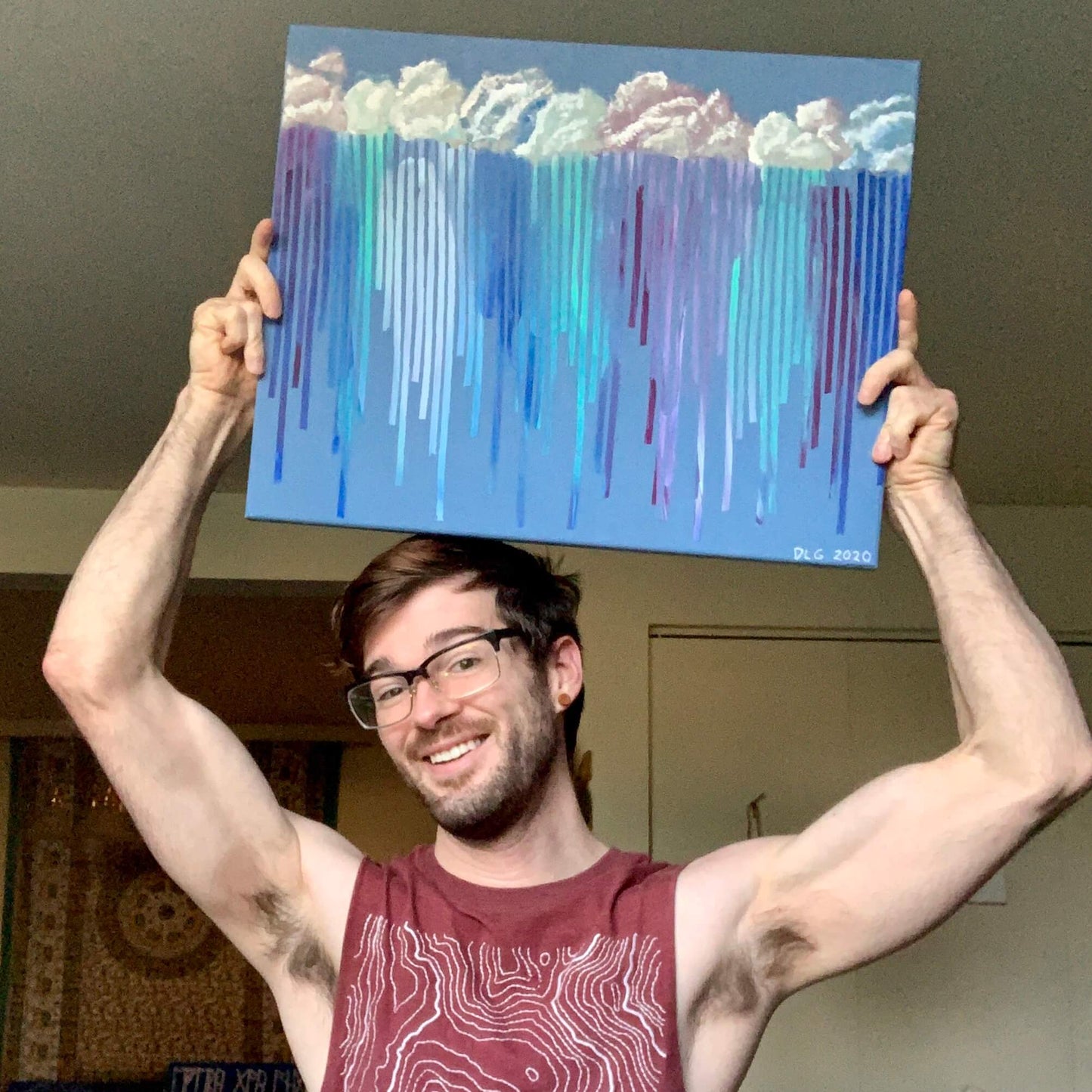 Artist Dorrin Gingerich holding the original Rain on Me abstract painting