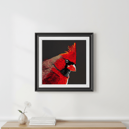 Framed red cardinal bird art print with black background hung on light gray wall above minimalist console with books and vase