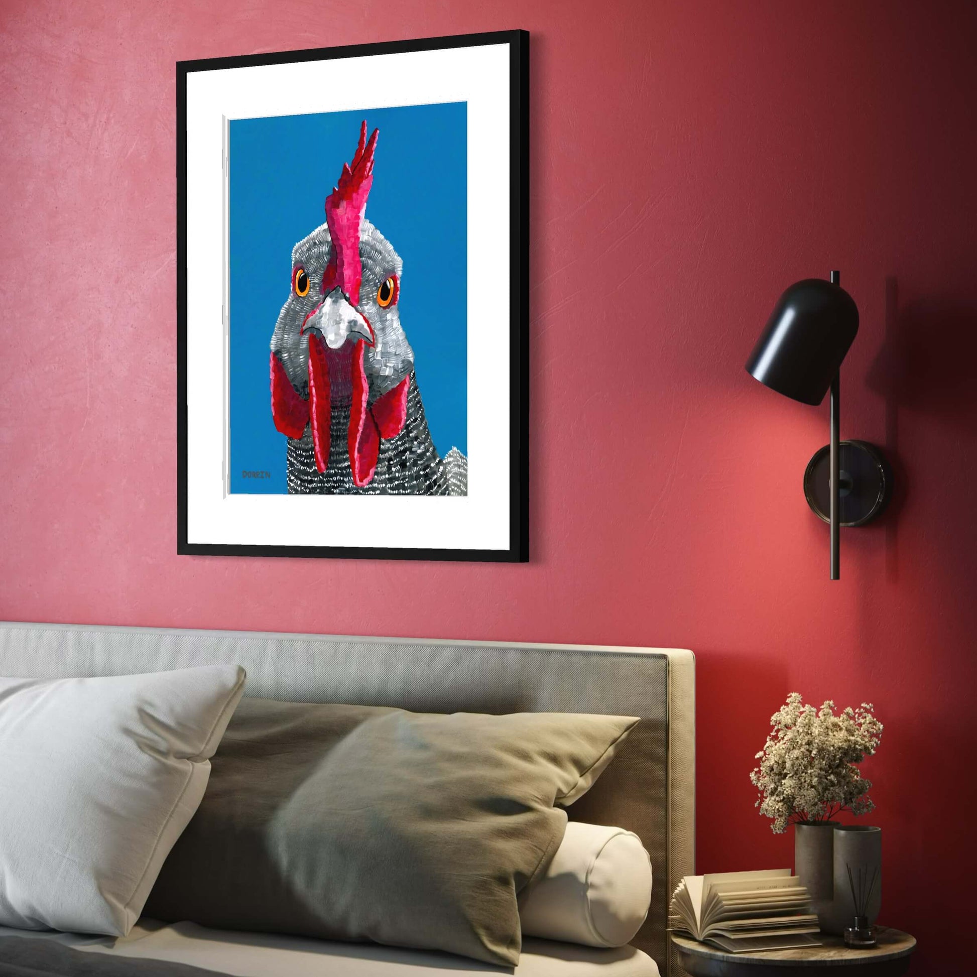 Dorrin Gingerich rooster fine art print in black frame hung above bed on deep red bedroom wall