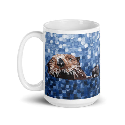 White ceramic mug featuring painted sea otter floating in textured blue water, left-handed handle view