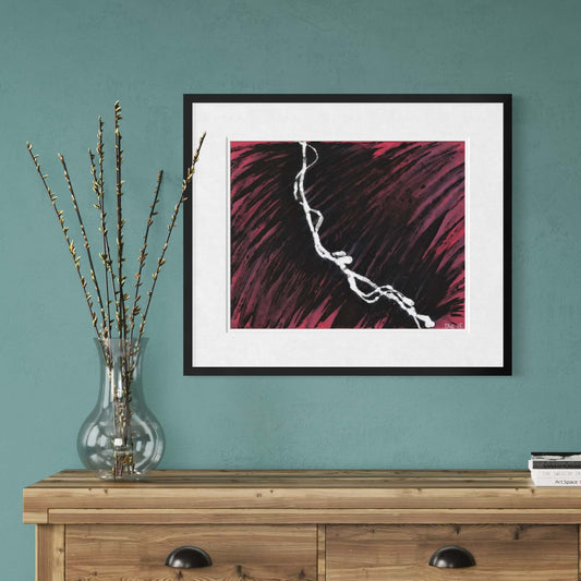 Framed Smoke Pink abstract print on a teal wall beside a glass vase of branches