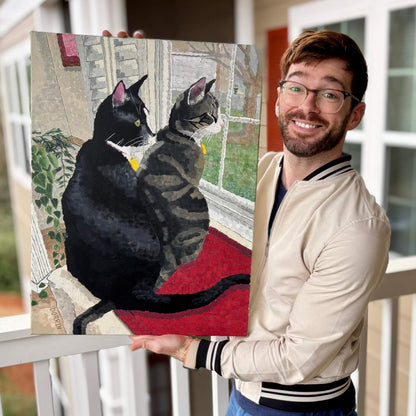 Dorrin Gingerich holding the original Window Watchers cat painting on his porch