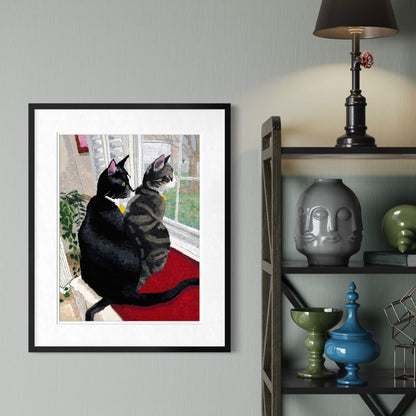 Framed cat print beside a bookshelf styled with vases and ceramic decor